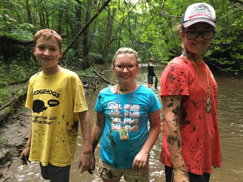 three kids at summer camp riverside